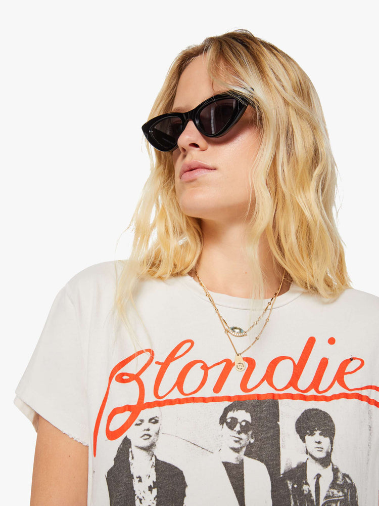 Close up view of a woman in a white tee pays homage to Blondie with a black-and-white photograph and the band's name in red on the front.