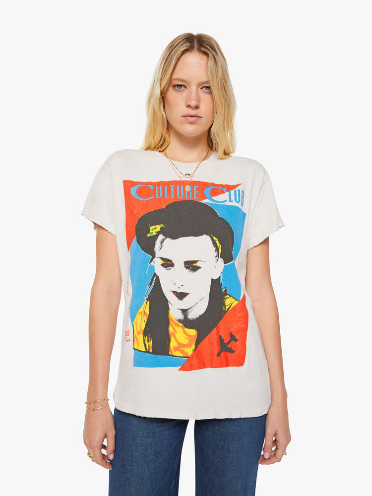 Front view of a woman in a white tee pays homage to Culture Club with a colorful portrait on the front.