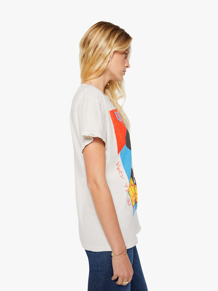 Side view of a woman in a white tee pays homage to Culture Club with a colorful portrait on the front.