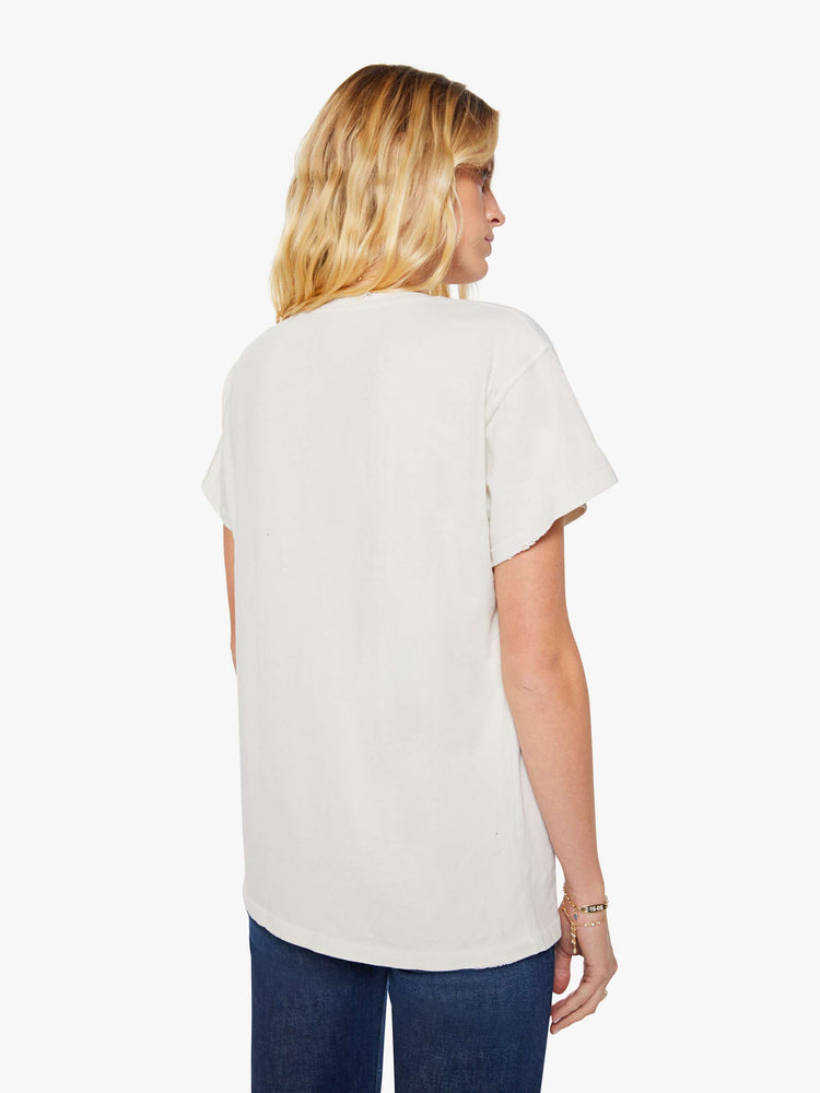 Back view of a woman in a white tee pays homage to Culture Club with a colorful portrait on the front.