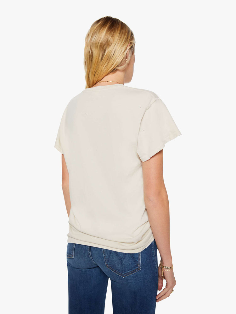 Back view of a woman in a cream tee pays homage to Tina Turner with a graphic portrait on the front.