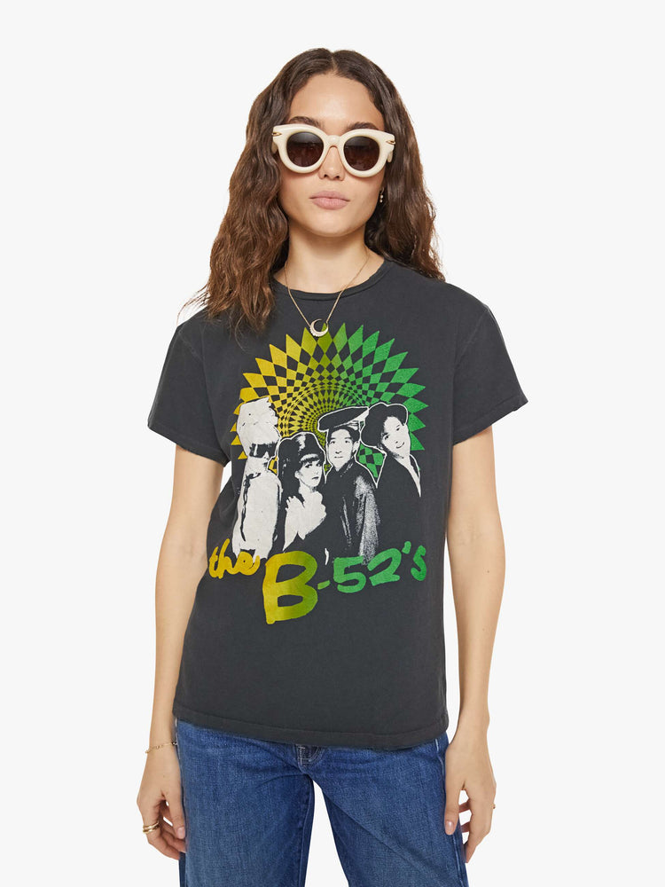 Front view of a woman in a black tee that pays homage to the B-52's with a graphic portrait on the front.