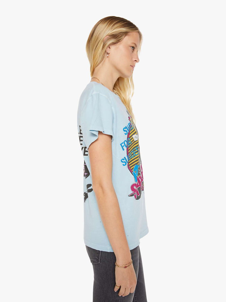 Side view of a woman in a blue tee with a Rick Springfield with a graphic portrait on the front and back.