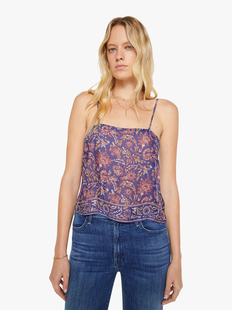 Front view of a woman in a blue and pink floral print, the Fern cami has a square neck, spaghetti straps and a cropped, boxy fit.