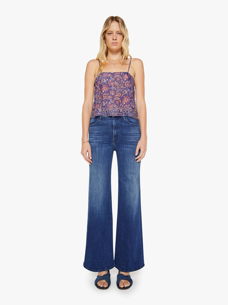 Full body view of a woman in a blue and pink floral print, the Fern cami has a square neck, spaghetti straps and a cropped, boxy fit.