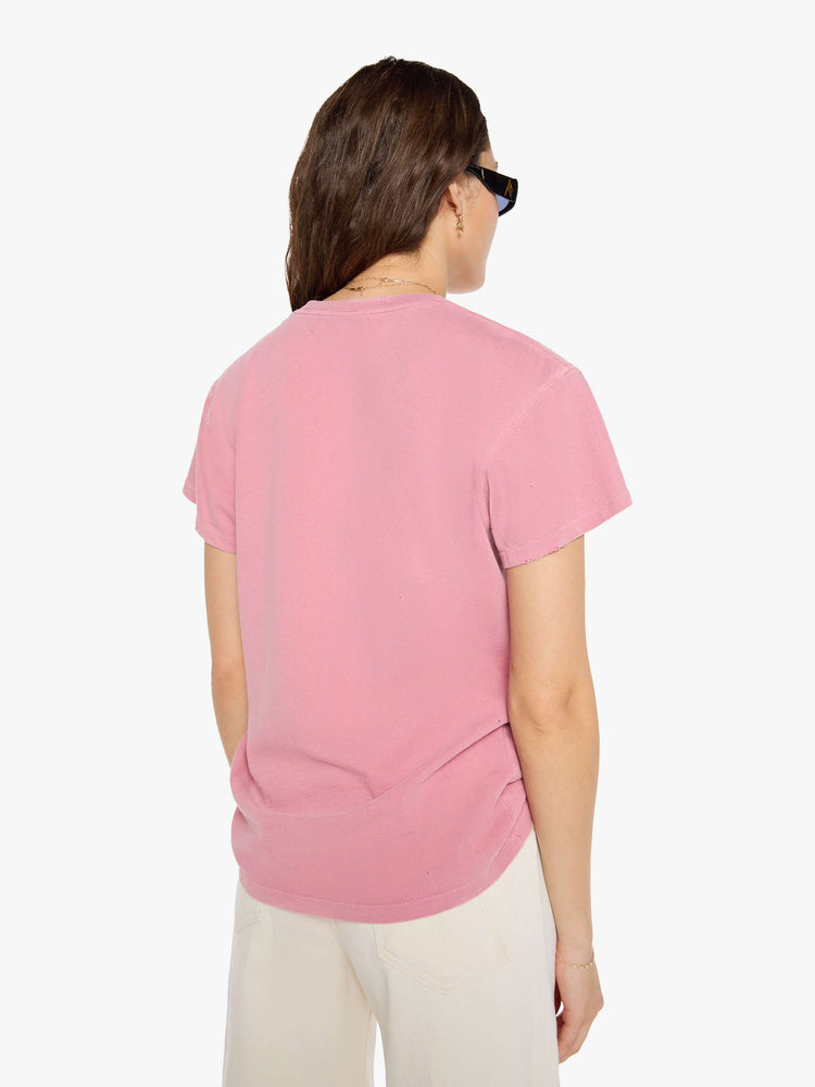Back  view of a woman in pink tee pays homage to The Beatles with a graphic portrait and text in blue on the front.