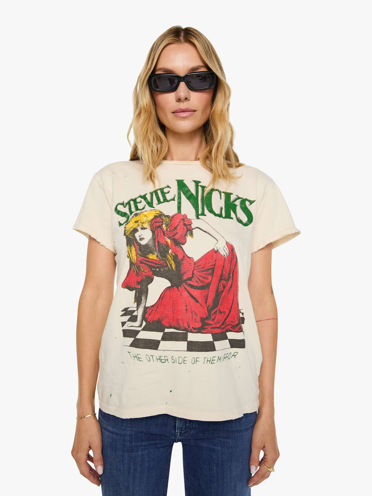 Front view of a woman in a tan tee pays homage to Stevie Nicks with a colorful portrait on the front.