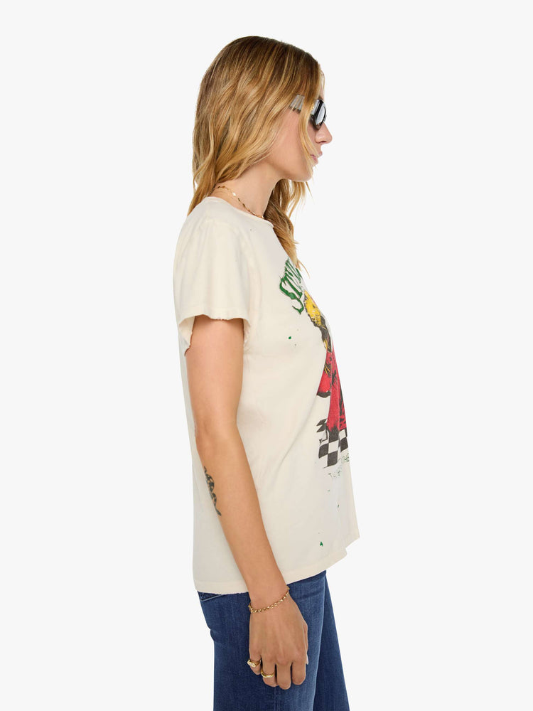 Side view of a woman in a tan tee pays homage to Stevie Nicks with a colorful portrait on the front.