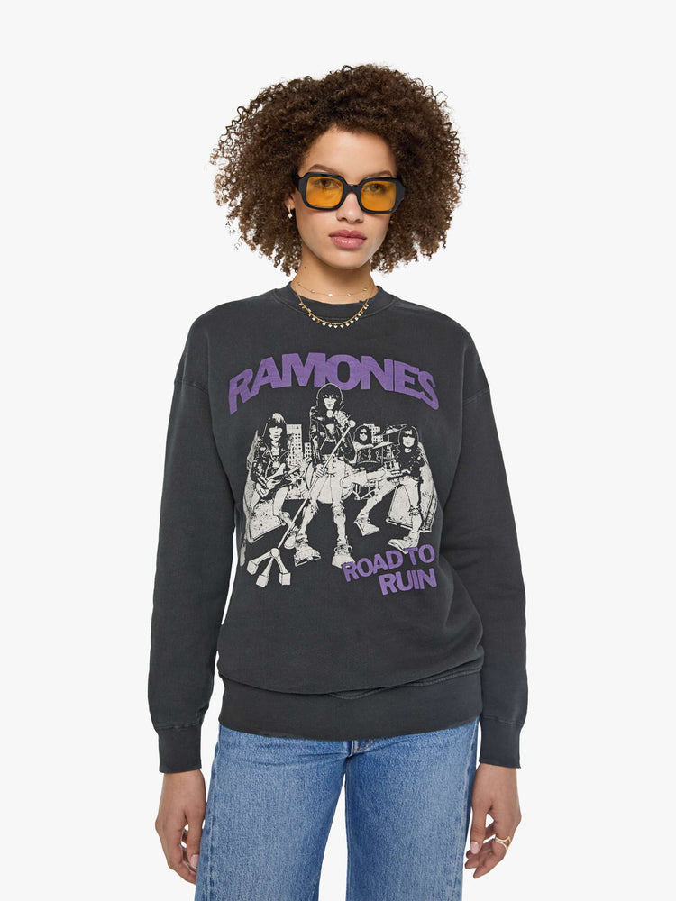 Front view of a woman in a faded black sweatshirt pays homage to The Ramones' eleventh studio album with a cream graphic and the band's name in purple on the front.
