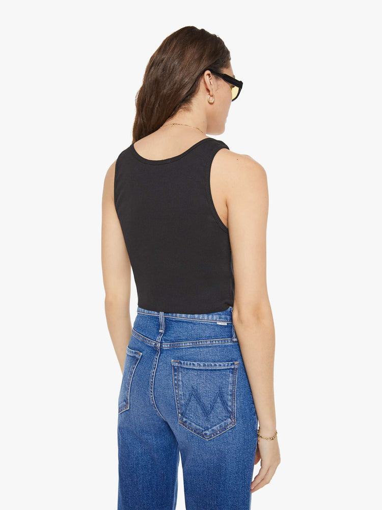 Back view of a woman in a black scoop neck tank is designed with a cropped fit.