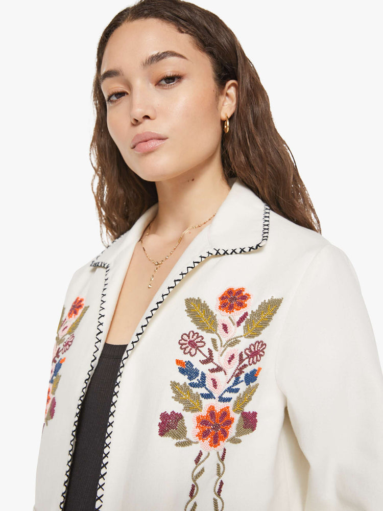 Close up view of a woman in a slightly dropped shoulders jacket, front patch pockets and a tailored fit that hugs the body like a blazer.