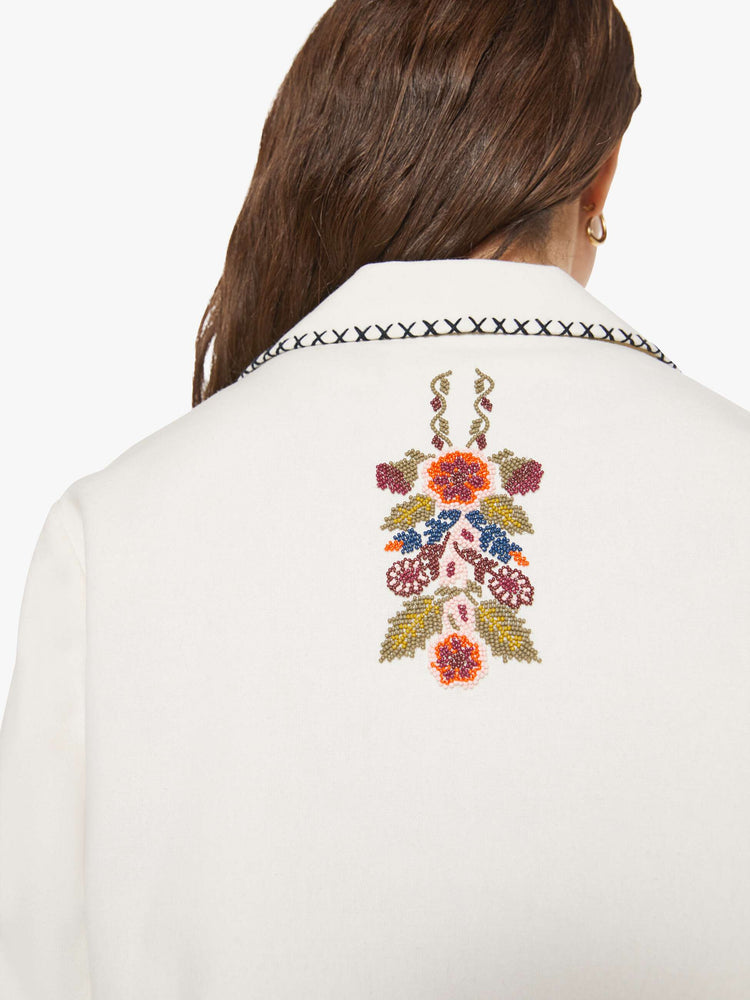 Back close up view of a woman in a slightly dropped shoulders jacket, front patch pockets and a tailored fit that hugs the body like a blazer.