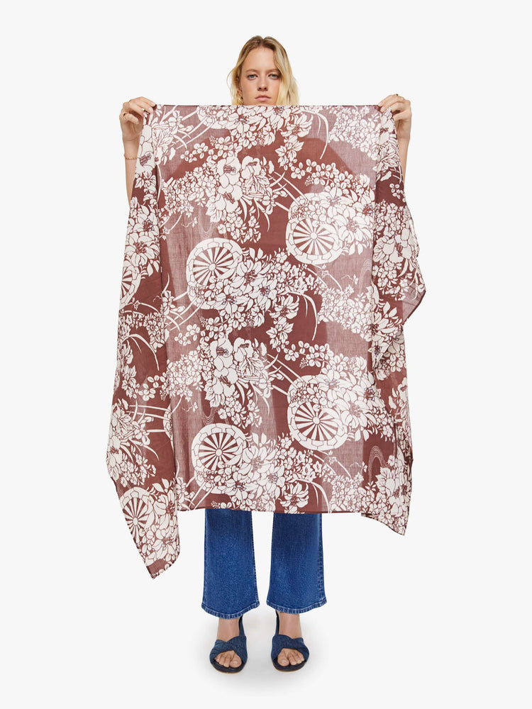Front view of a woman in a brown with a white vintage-inspired print scarf, can be worn as a dress, top, skirt or accessory.