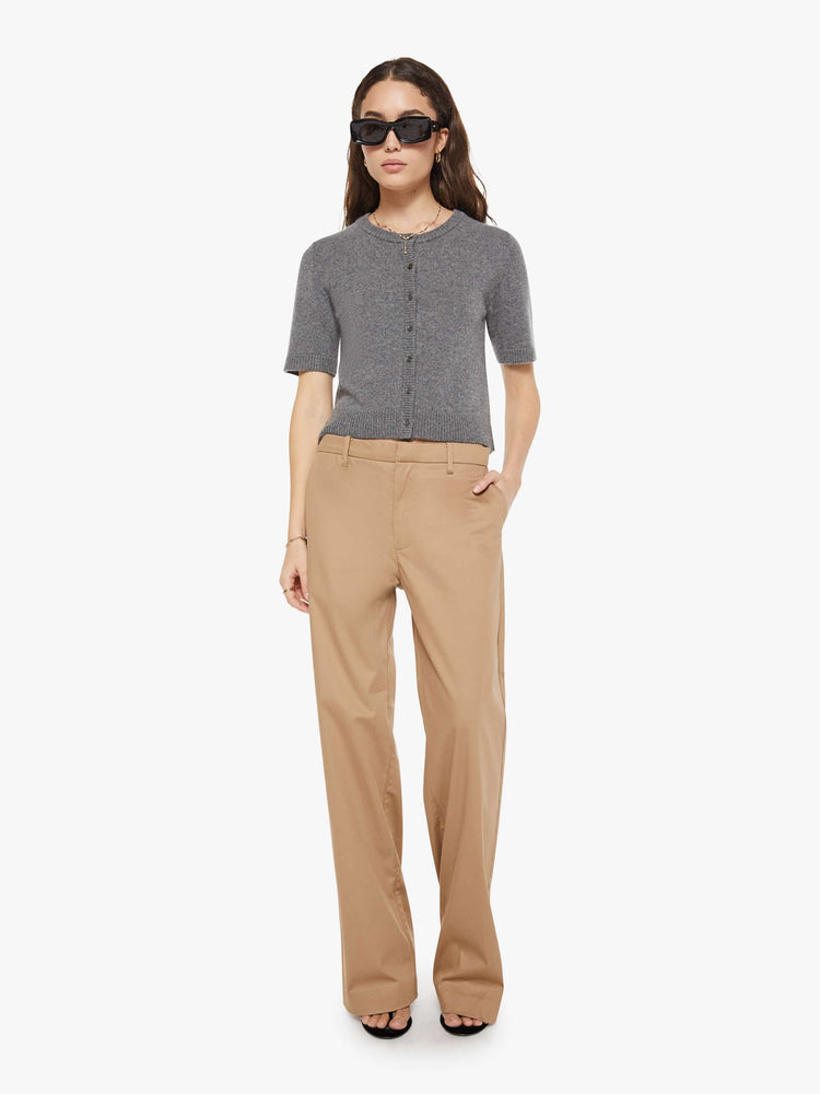Full body view of a woman in short-sleeve cardigan from the Los Angeles brand SPRWMN (pronounced "superwoman") Made from 100% cashmere in grey, the sweater has a crewneck and a slightly cropped fit.