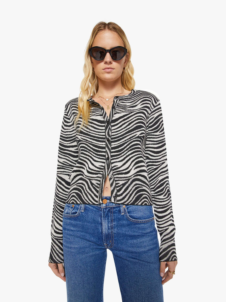Front view of a woman in a  zebra print cardigan.