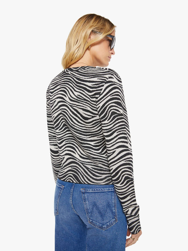 Back view of a woman in a  zebra print cardigan.