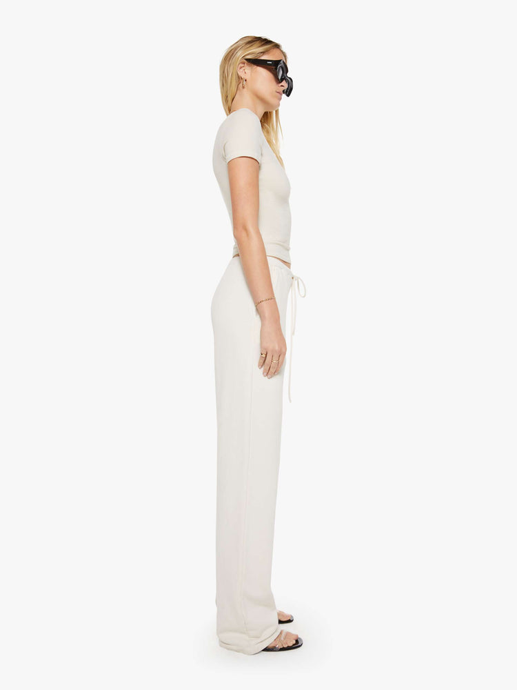 Side view of a woman in  with a straight leg, drawstring waistband, long inseam and a loose, comfortable fit. 