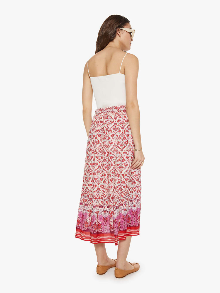 Back view of a woman in a cream and pink graphic print  with a high rise and a loose, straight fit. 