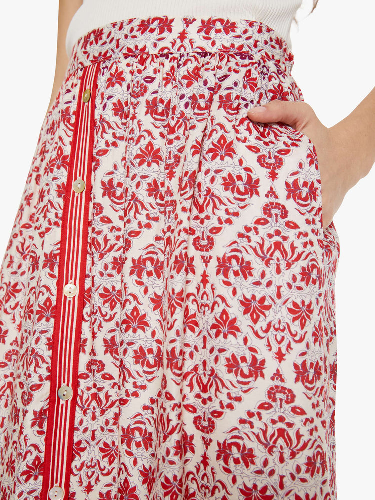 Close up view of a woman in a cream and pink graphic print  with a high rise and a loose, straight fit. 