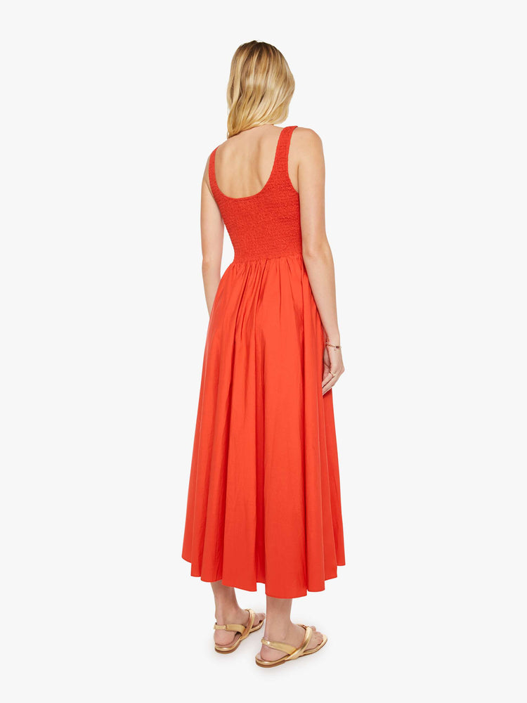Back view of a woman in bright red sleeveless midi dress.