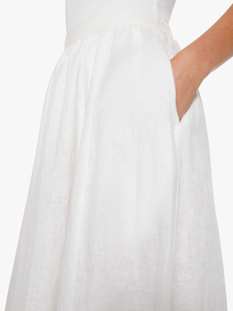 Close up view of a woman in a white with navy stripes with a high rise, slit pockets and a loose, flowy fit.