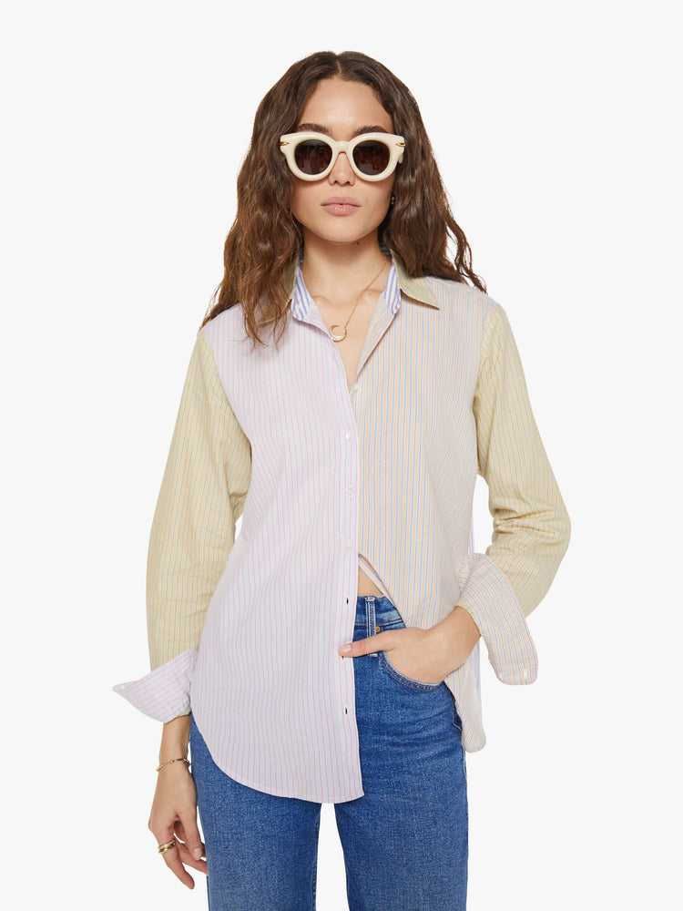 Front view of a woman in sage green and light blue striped button-down.