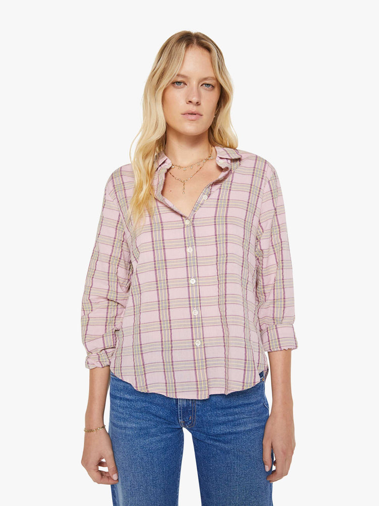 Front view of a woman in a pink plaid print shirt with elbow-length sleeves, a curved hem and a loose fit.