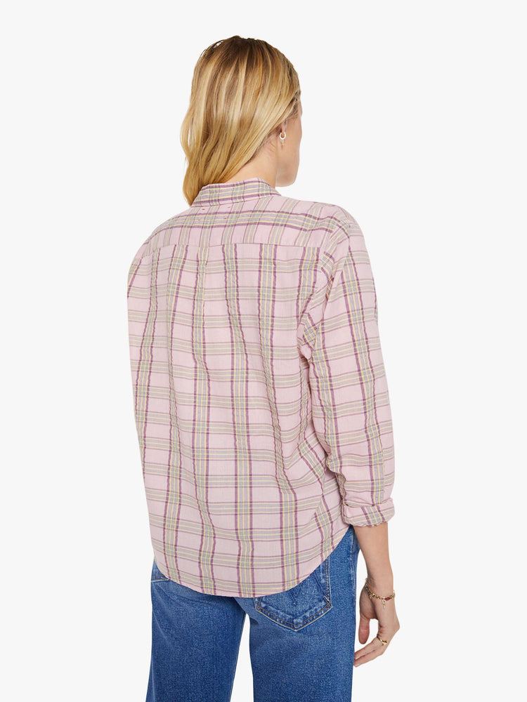 Back view of a woman in a pink plaid print shirt with elbow-length sleeves, a curved hem and a loose fit.