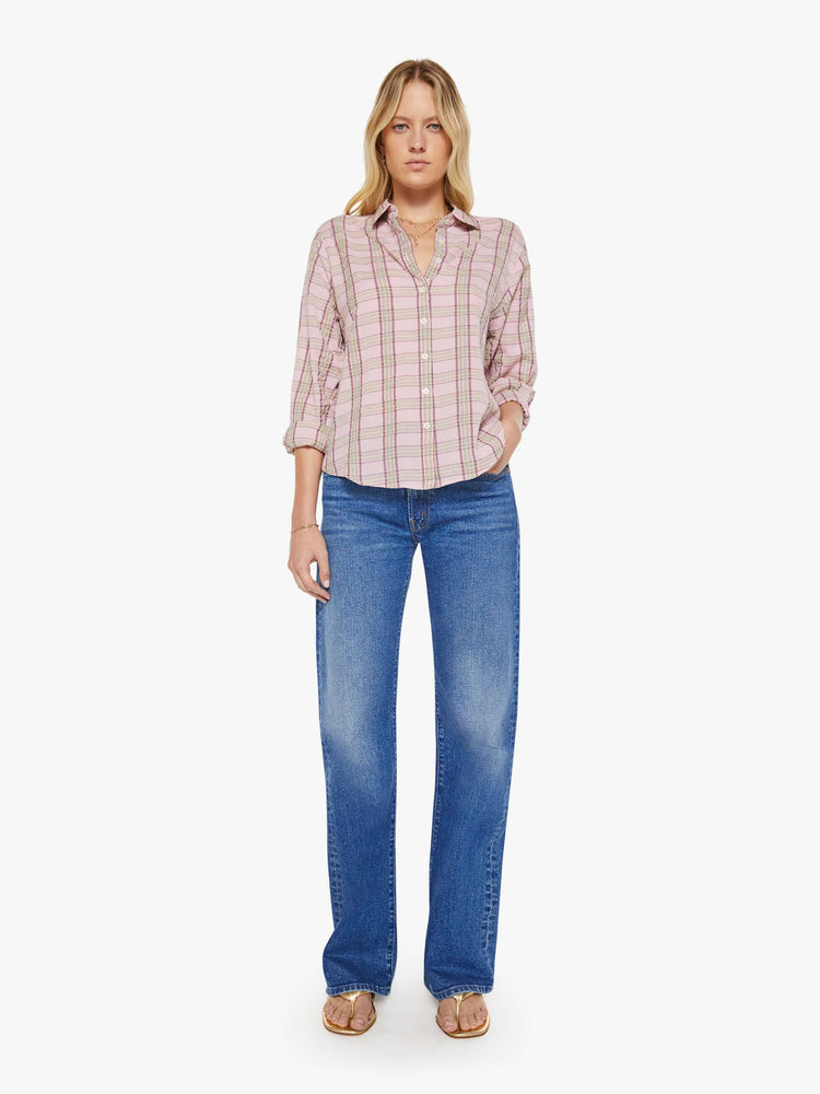 Full body view of a woman in a pink plaid print shirt with elbow-length sleeves, a curved hem and a loose fit.
