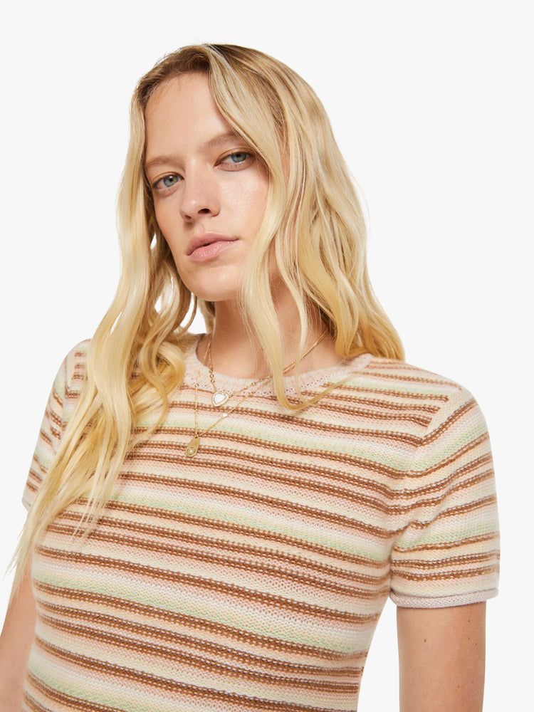 Close up view of a woman in a warm-toned stripes, the Jude tee is designed with a crewneck, short sleeves and a slightly shrunken fit.