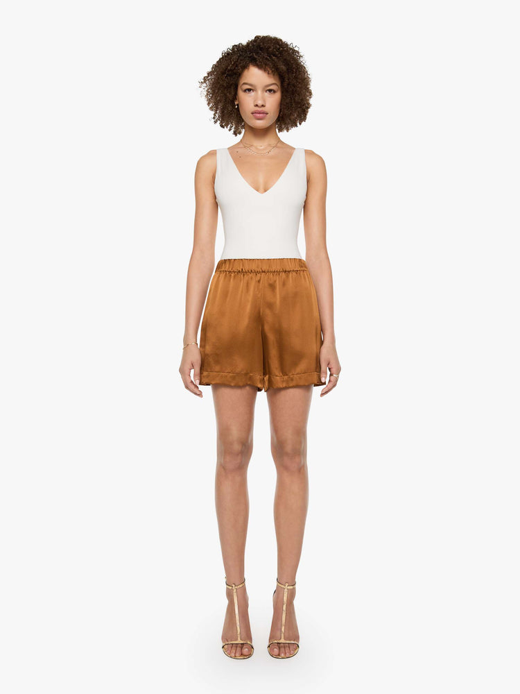 Front view of a woman in shorts are designed with a high rise, side slit pockets and a loose straight leg.