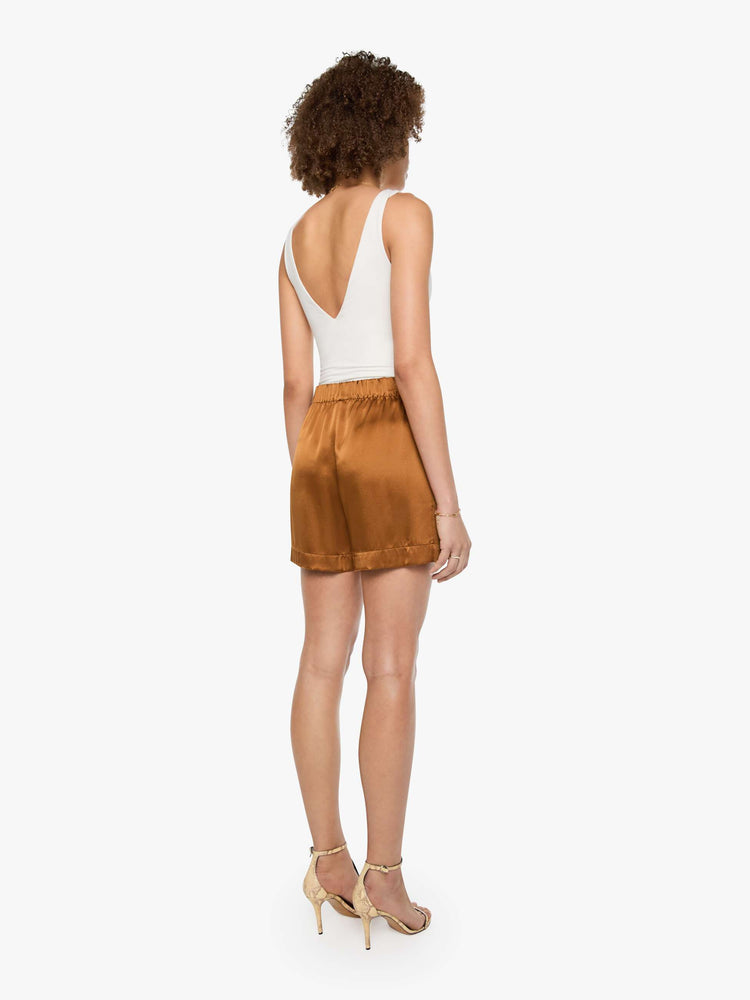 Back view of a woman in shorts are designed with a high rise, side slit pockets and a loose straight leg.