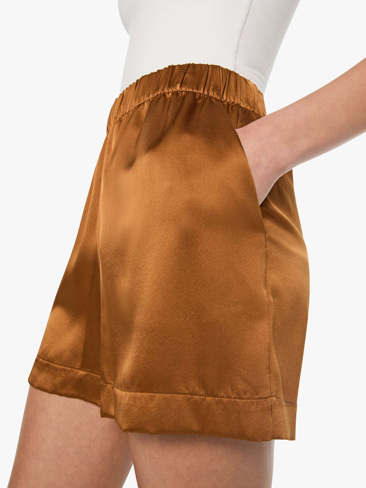 Close up view of a woman in shorts are designed with a high rise, side slit pockets and a loose straight leg.