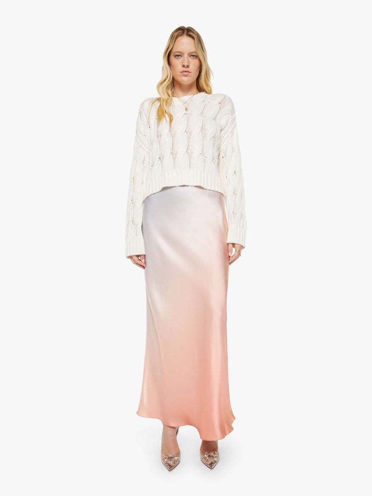 Full body view of a woman in a  top is designed with a crewneck, long sleeves, ribbed hems and a slightly oversized fit.