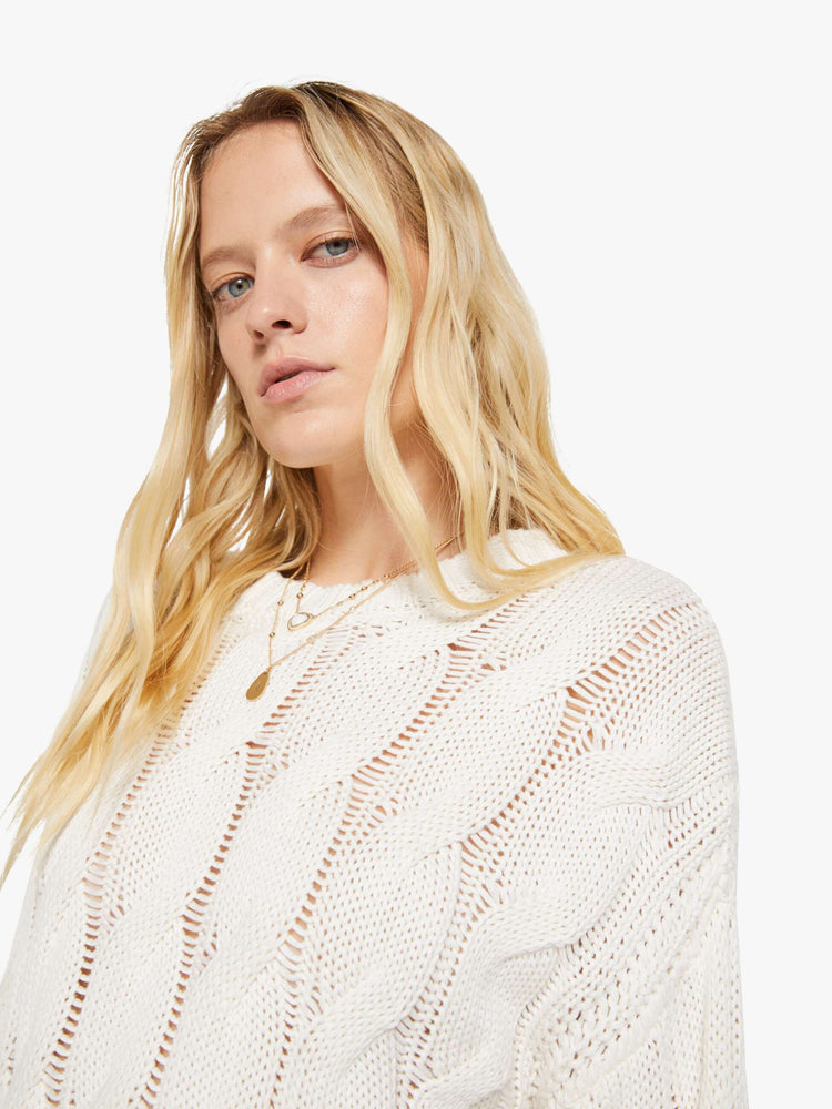 Close up view of a woman in a  top is designed with a crewneck, long sleeves, ribbed hems and a slightly oversized fit.