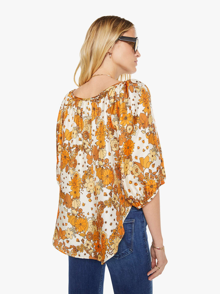 Back view of a woman in a vintage-inspired prints with classic silhouettes, featuring 3/4-length balloon sleeves and a flowy fit.