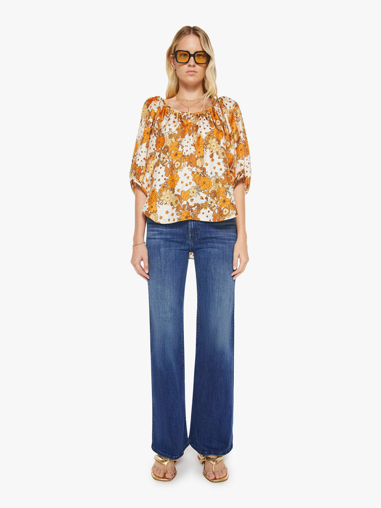Full body view of a woman in a vintage-inspired prints with classic silhouettes, featuring 3/4-length balloon sleeves and a flowy fit.