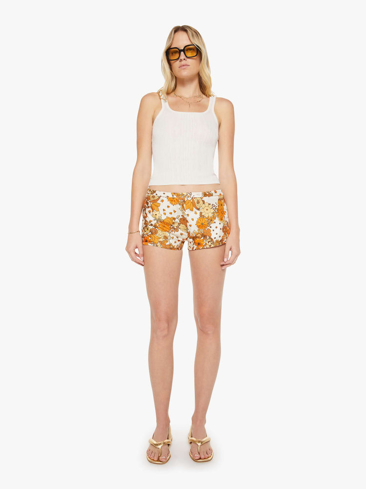 Front view of a woman in a floral print low-rise micro shorts.