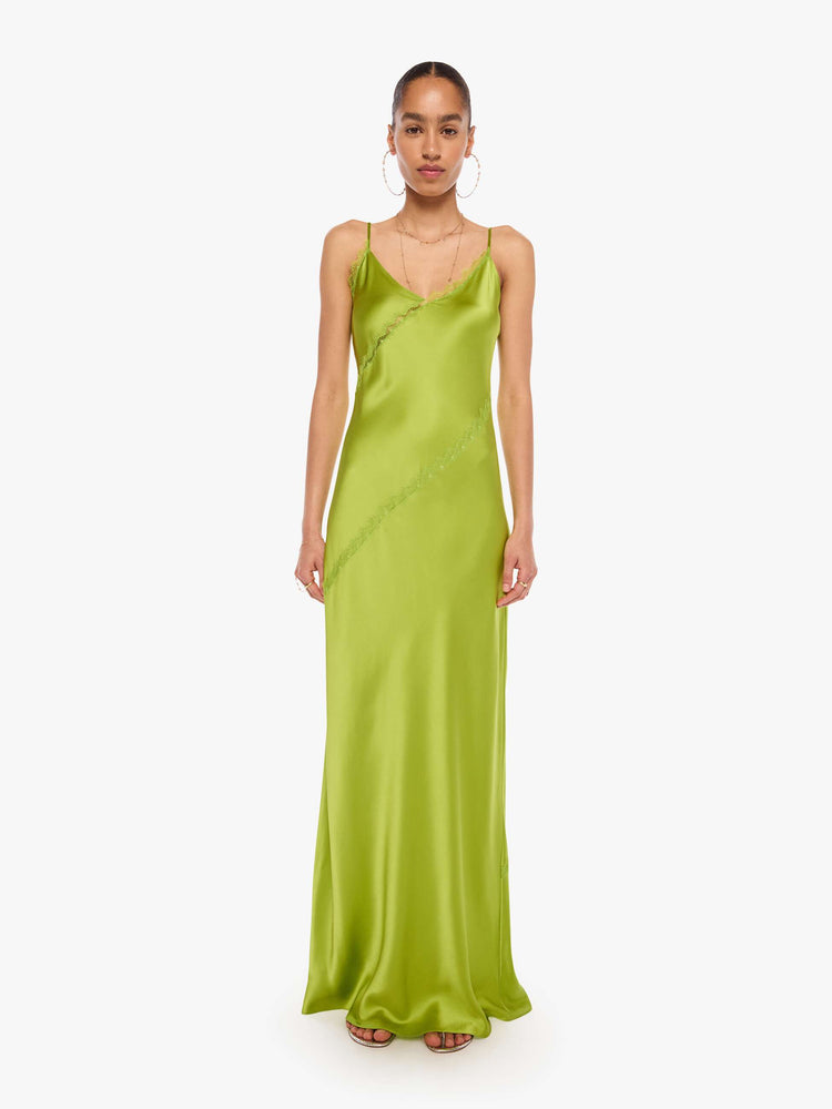 Front view of a woman in a silk chartreuse slip dress is designed with thin spaghetti straps, a V-neck, lace inset details, a floor-length hem and a loose, flowy fit.