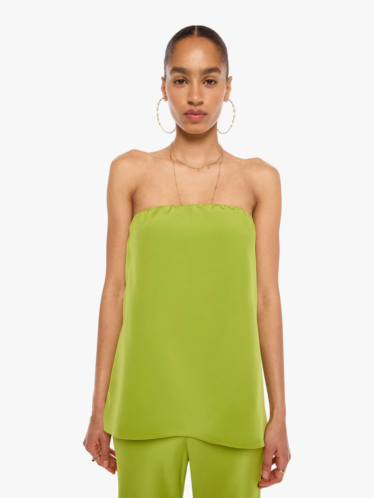Front view of a woman in a green strapless top with a loose, flowy fit.