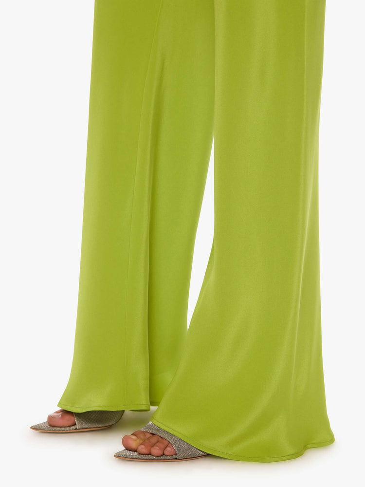 Hem view of a woman in a green pant with an elastic waistband, a loose leg and an extra-long hem.