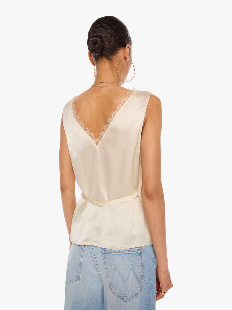 Back view of a woman in a tank is designed with a V-neck, thick straps and a loose fit.