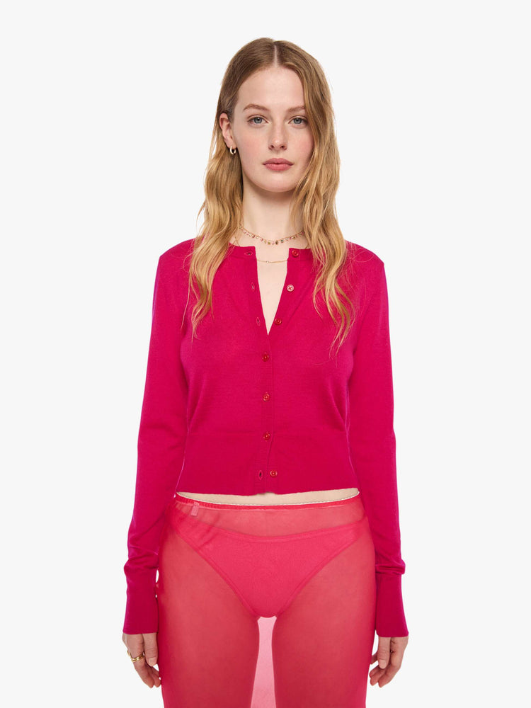 Front view of a woman in a hot pink cardigan from SPRWMN with a crewneck and a narrow fit.
