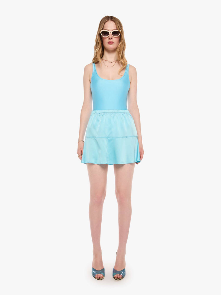 Front view of a woman in a baby blue mini skirt from SPRWMN with a high rise, thigh-grazing hem and a loose, flowy fit.