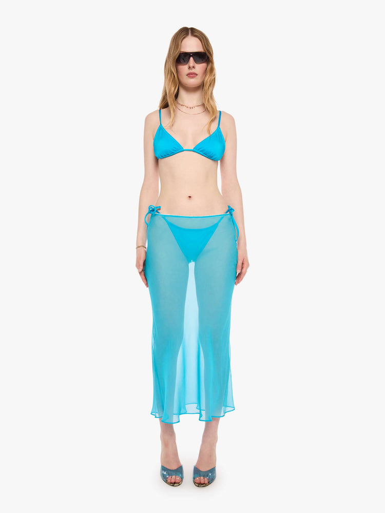 Front view of a woman in a turquoise see-through maxi skirt from SPRWMN with an elastic waist, narrow fit and ankle-length hem. 