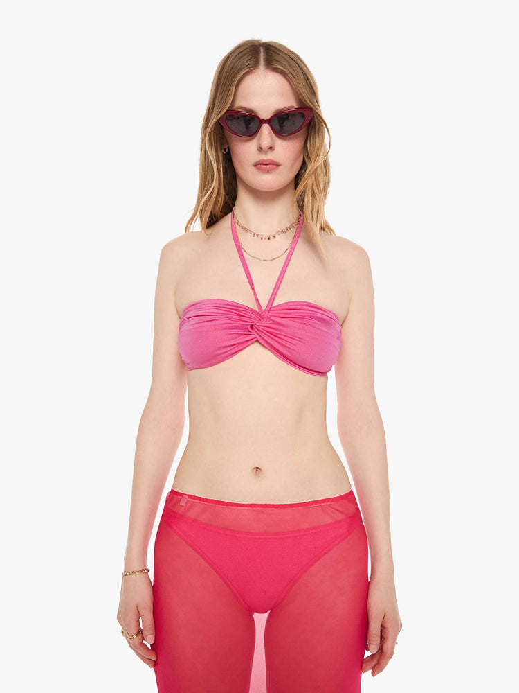 Front view of a woman in a pink bikini top from SPRWMN with an adjustable fit has a twisted bandeau design and removable straps.