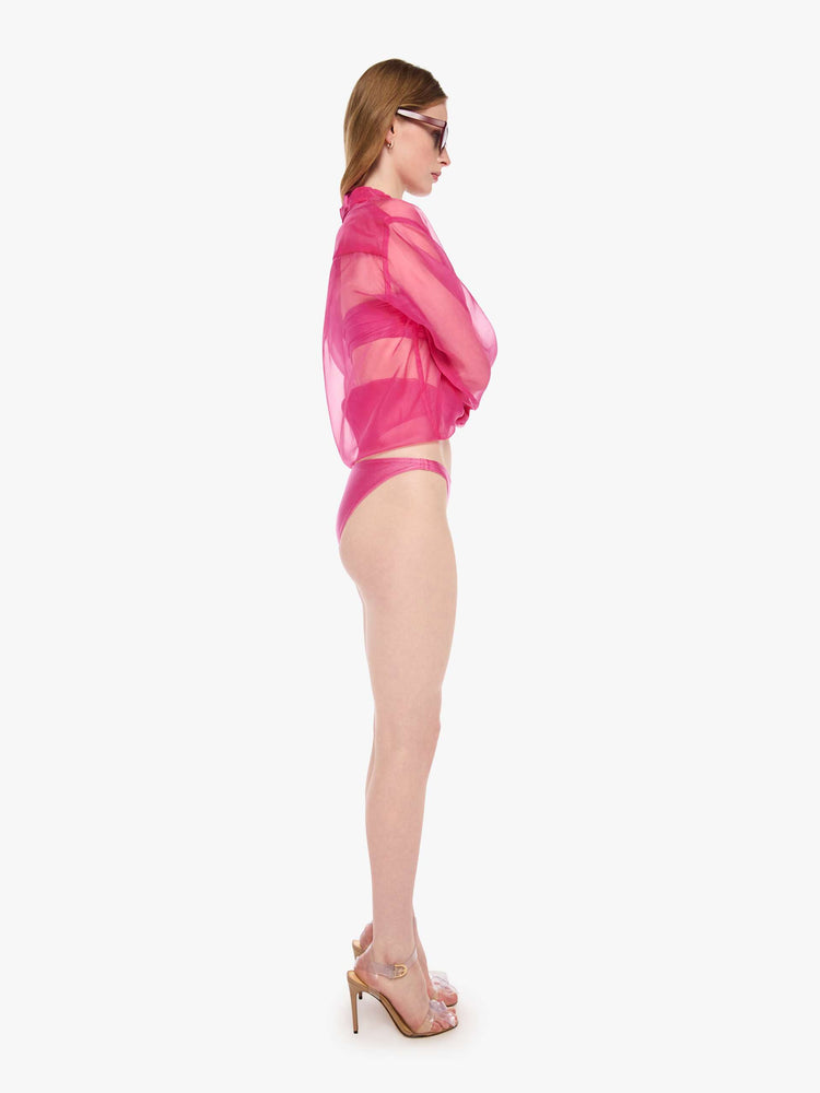Side view of a woman in a classic bikini bottoms from SPRWMN designed in pink with a high-leg fit.