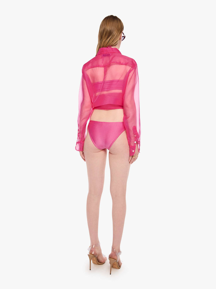 Back view of a woman in a classic bikini bottoms from SPRWMN designed in pink with a high-leg fit.