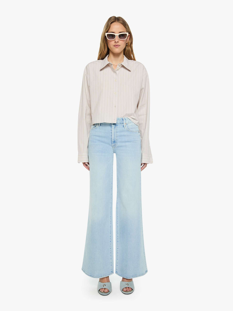 Front full body view of a woman in a grey with cream stripes button up top designed with a cropped, boxy fit. 