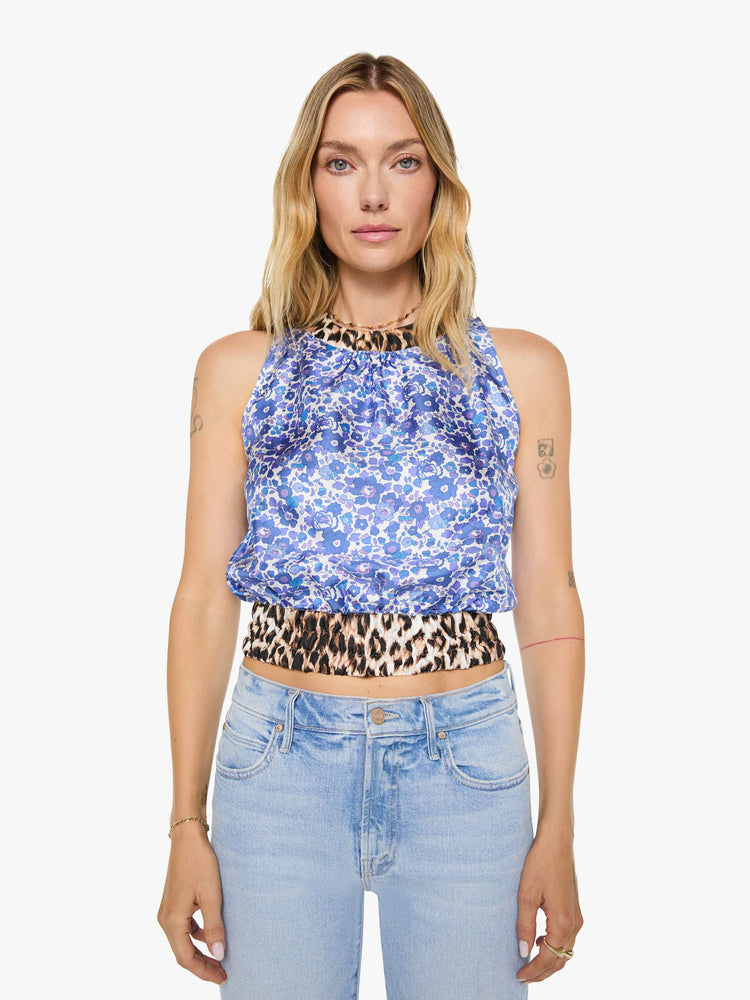 Front view of a woman in blue and white floral print with cheetah print trim shirt with crewneck, wide, gathered hem and slightly cropped fit.